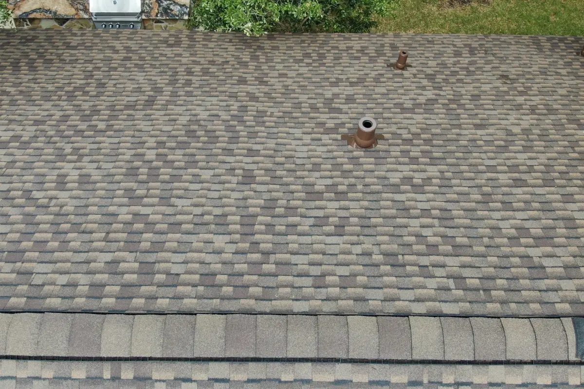Aerial view of new pipe boots and ridge vent on a completed IMPACTSHIELD roof in Bergheim, TX