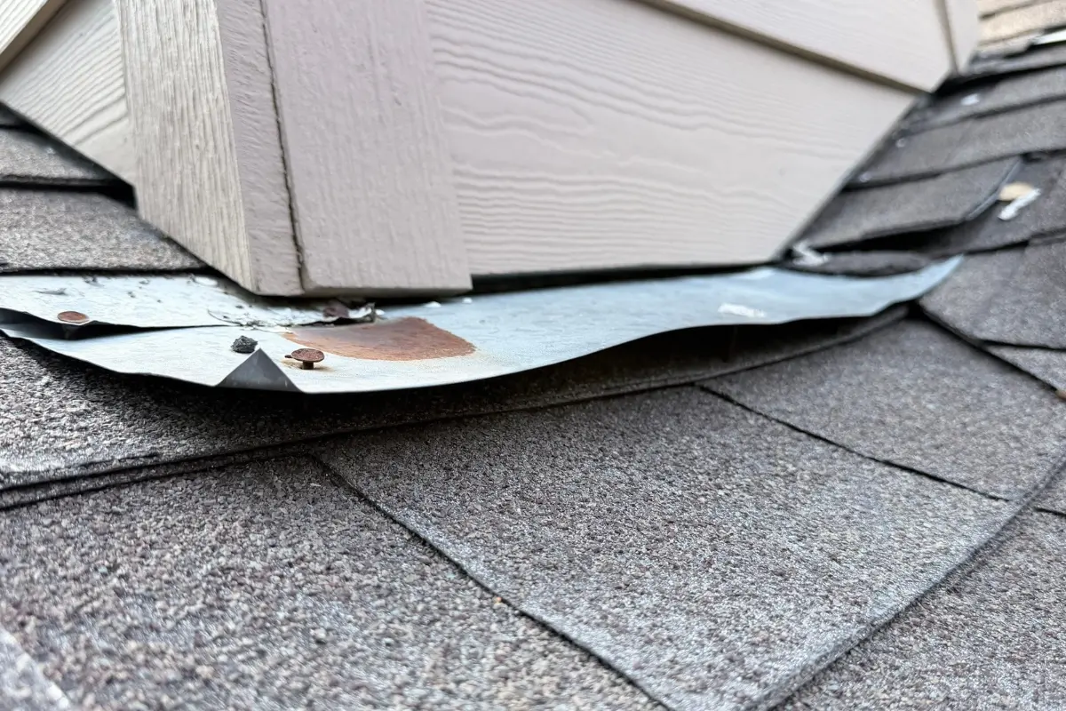 Lifted flashing around a chimney on a Bergheim, TX roof found during inspection