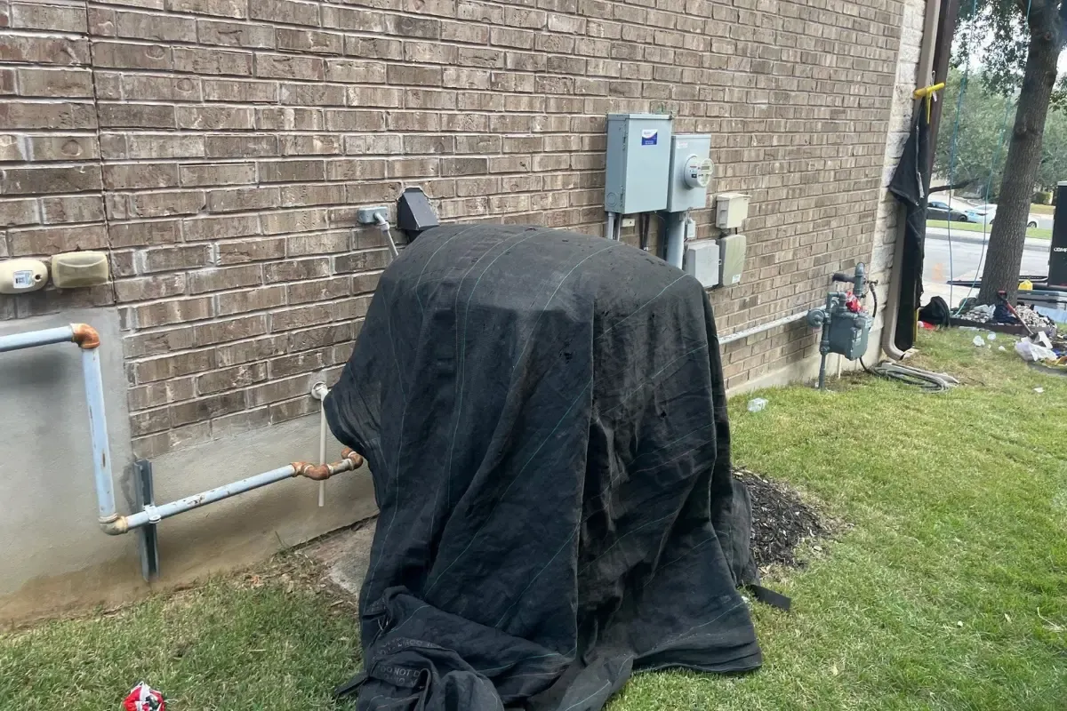 Install day: A/C unit covered before tear-off in Indian Springs, San Antonio, TX