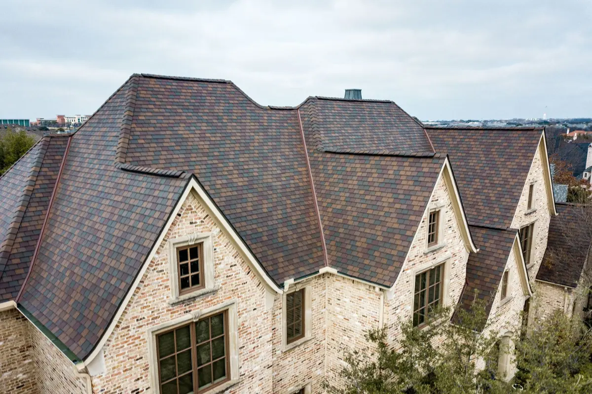 Stone Oak home with a lifetime engineered designer shingle roofing system by Atrium Roofing