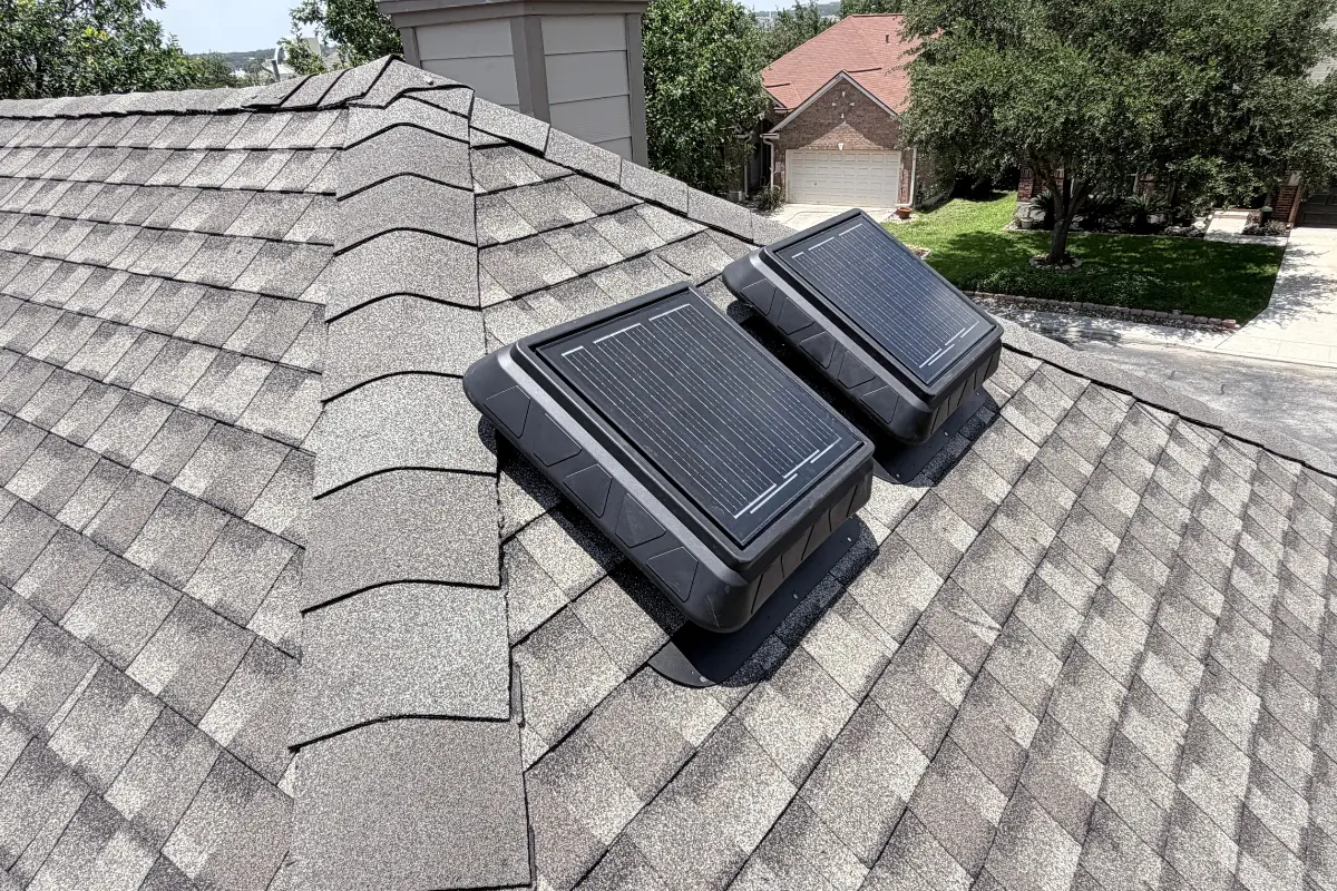 Solar-powered attic vents on a lifetime engineered asphalt shingle roof in New Braunfels